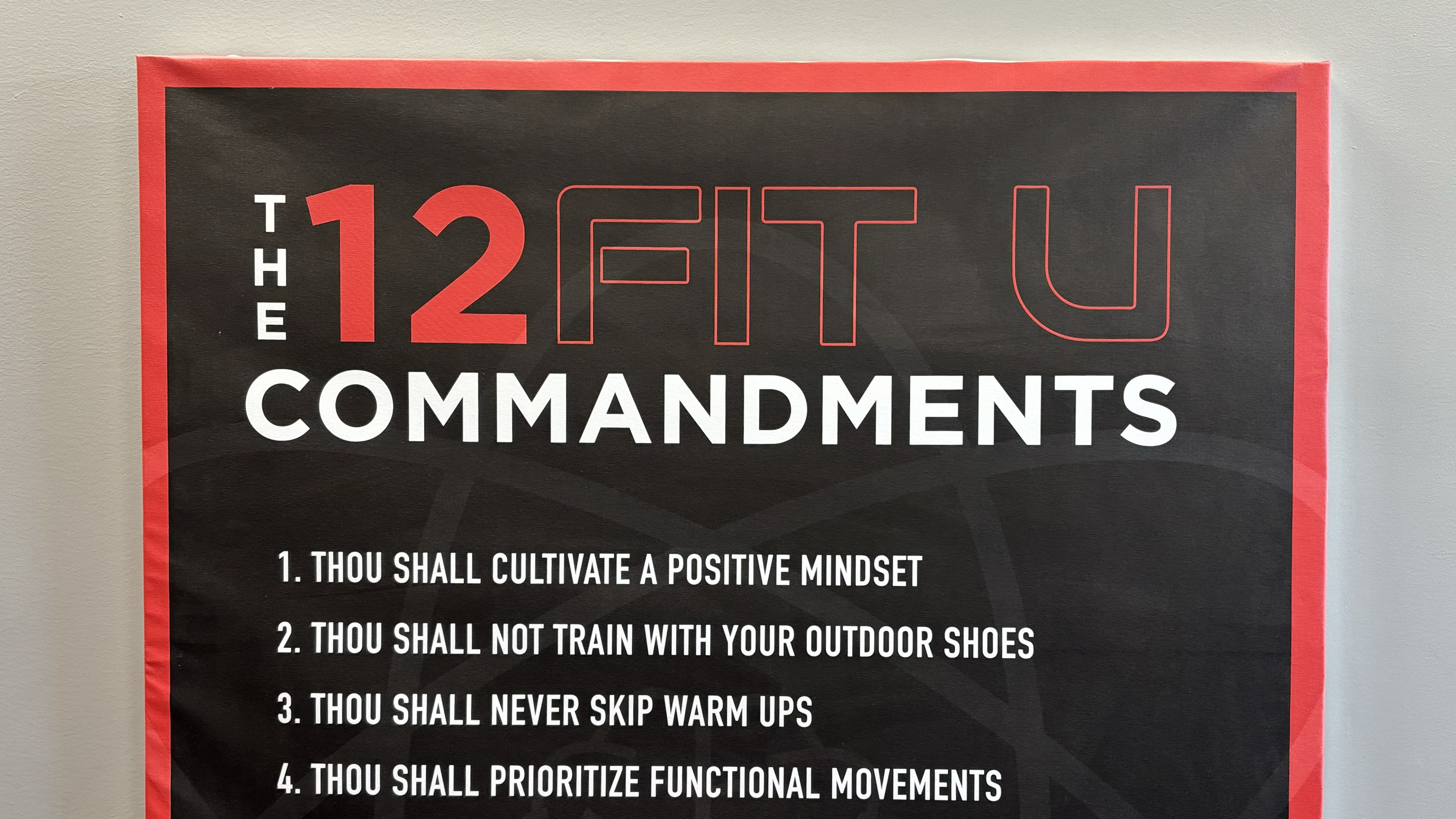 Image des '12 Commandements' chez Studio Fit U, affichant les principes clés du gym privé à Montréal qui distinguent leurs services haut de gamme des gyms commerciaux traditionnels.