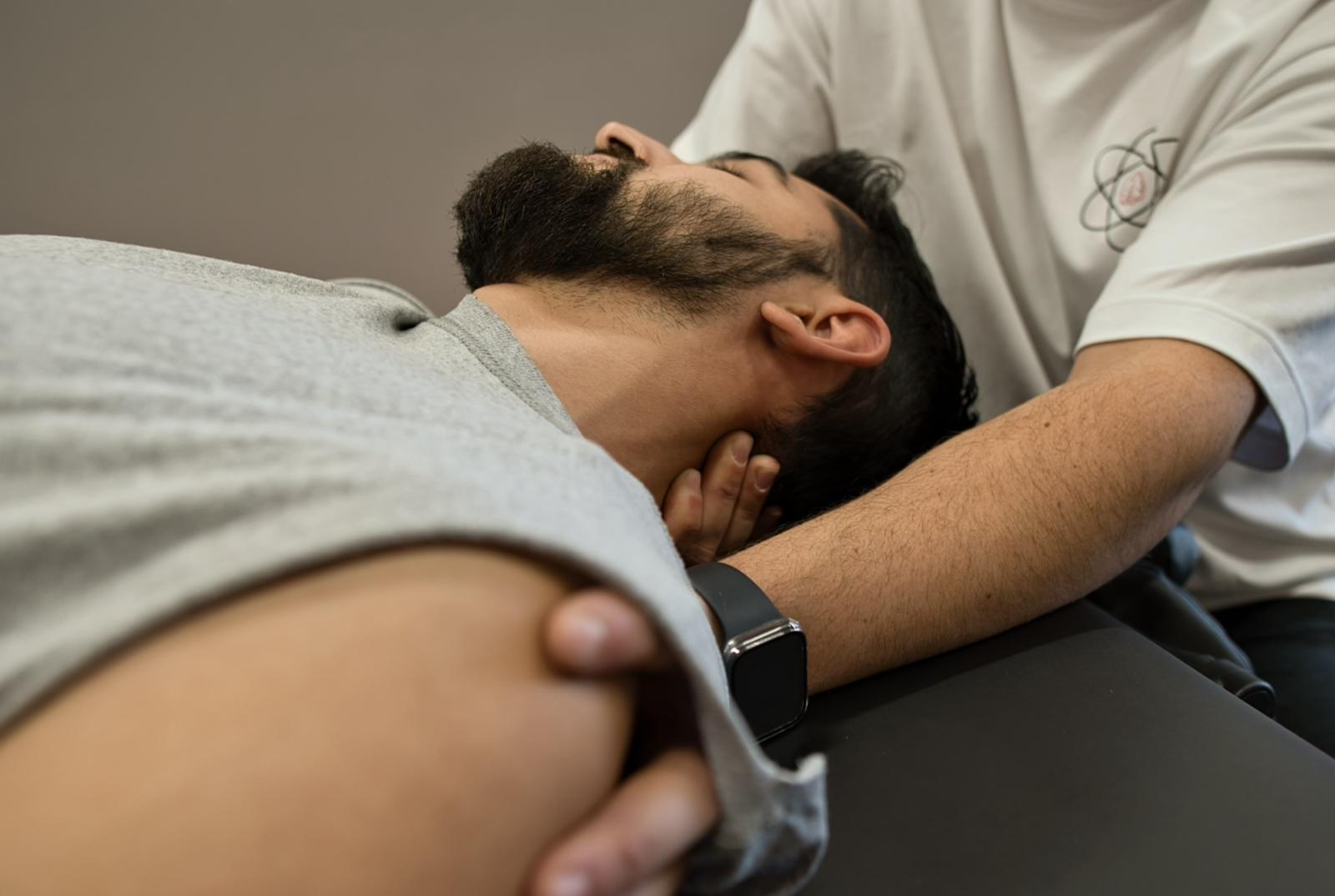 Studio Fit U sports therapist assisting a patient in sports rehabilitation, demonstrating their skills as an Athletic Therapist in Montreal.